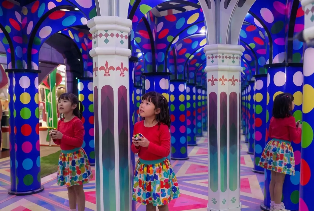 Children exploring a commercial mirror maze attraction